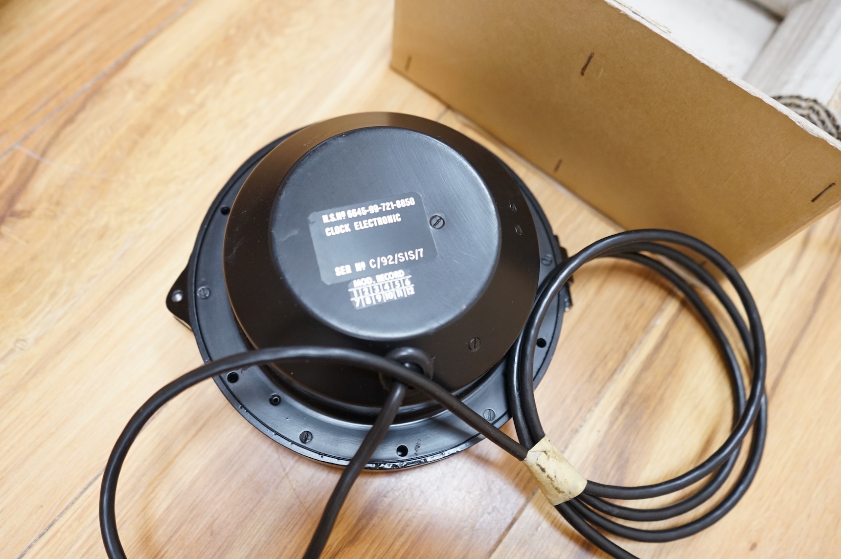 A modern British MOD Royal Navy issue quartz powered electric timepiece by S.I.R.S. Navigation Ltd. in its original card issue box